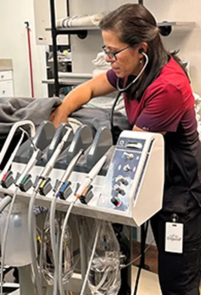 A technician using dental equipment A technician using dental equipment