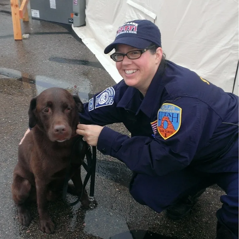 Dr. Laura McLain holding a corgi with its tongue hanging out Dr. Laura McLain holding a corgi with its tongue hanging out