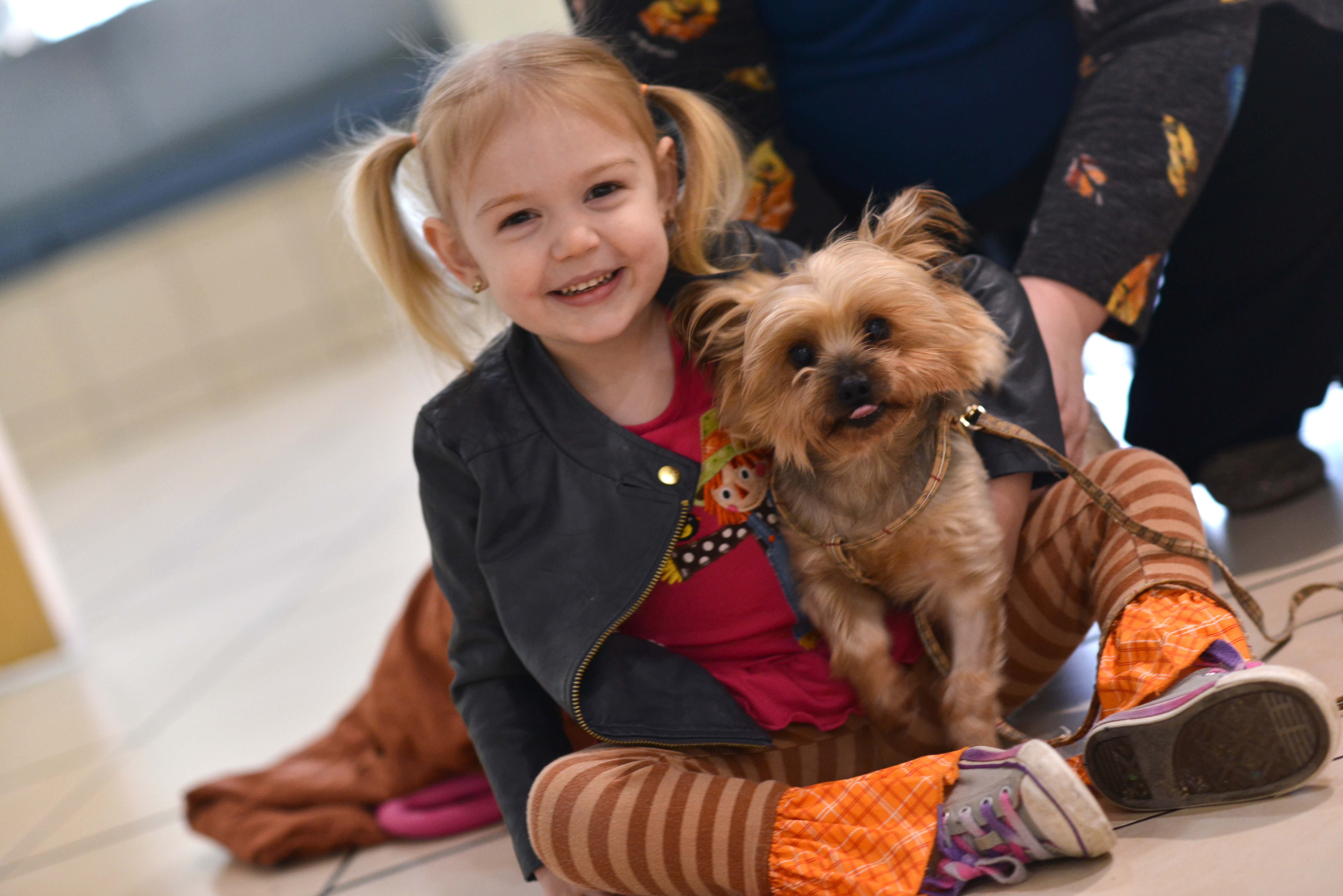 Little girl sitting with puppy