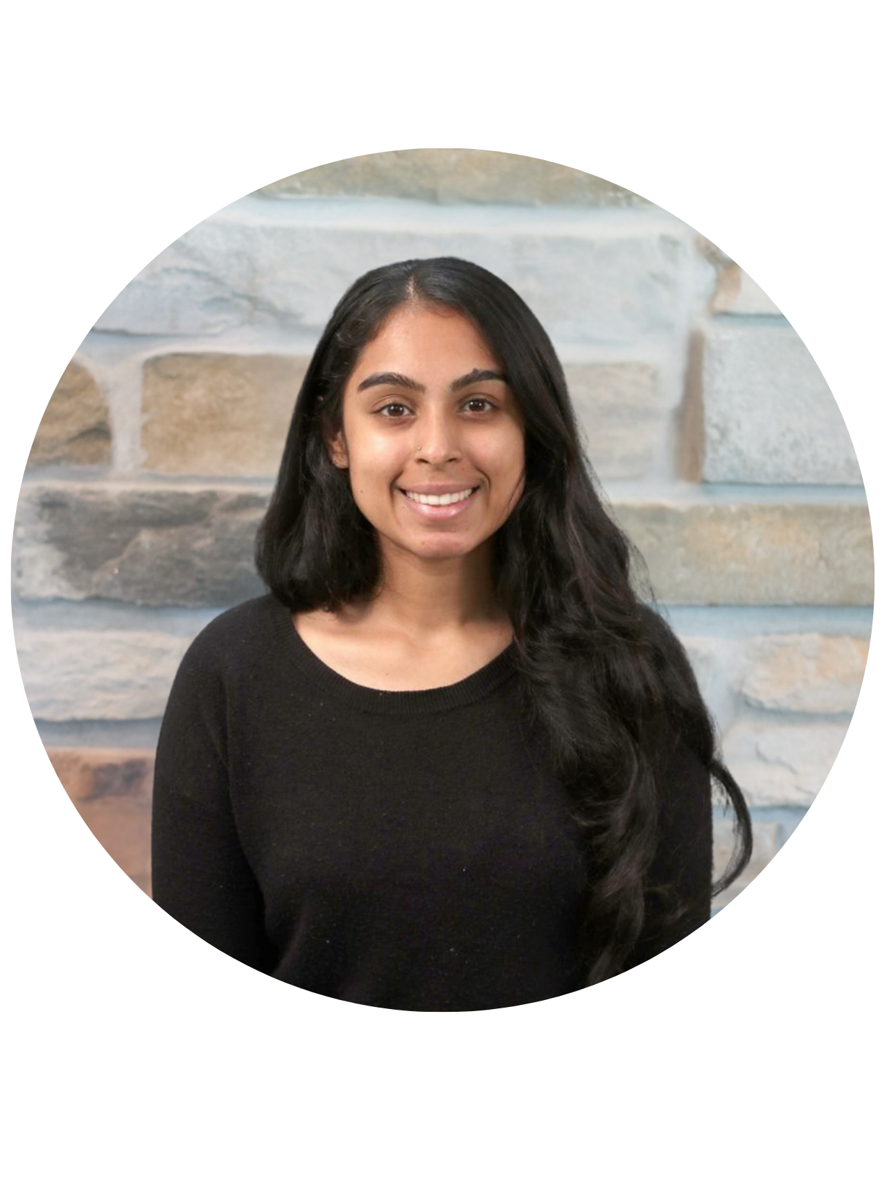 Dr. Anu Srinath smiling in headshot, wearing a blue blouse