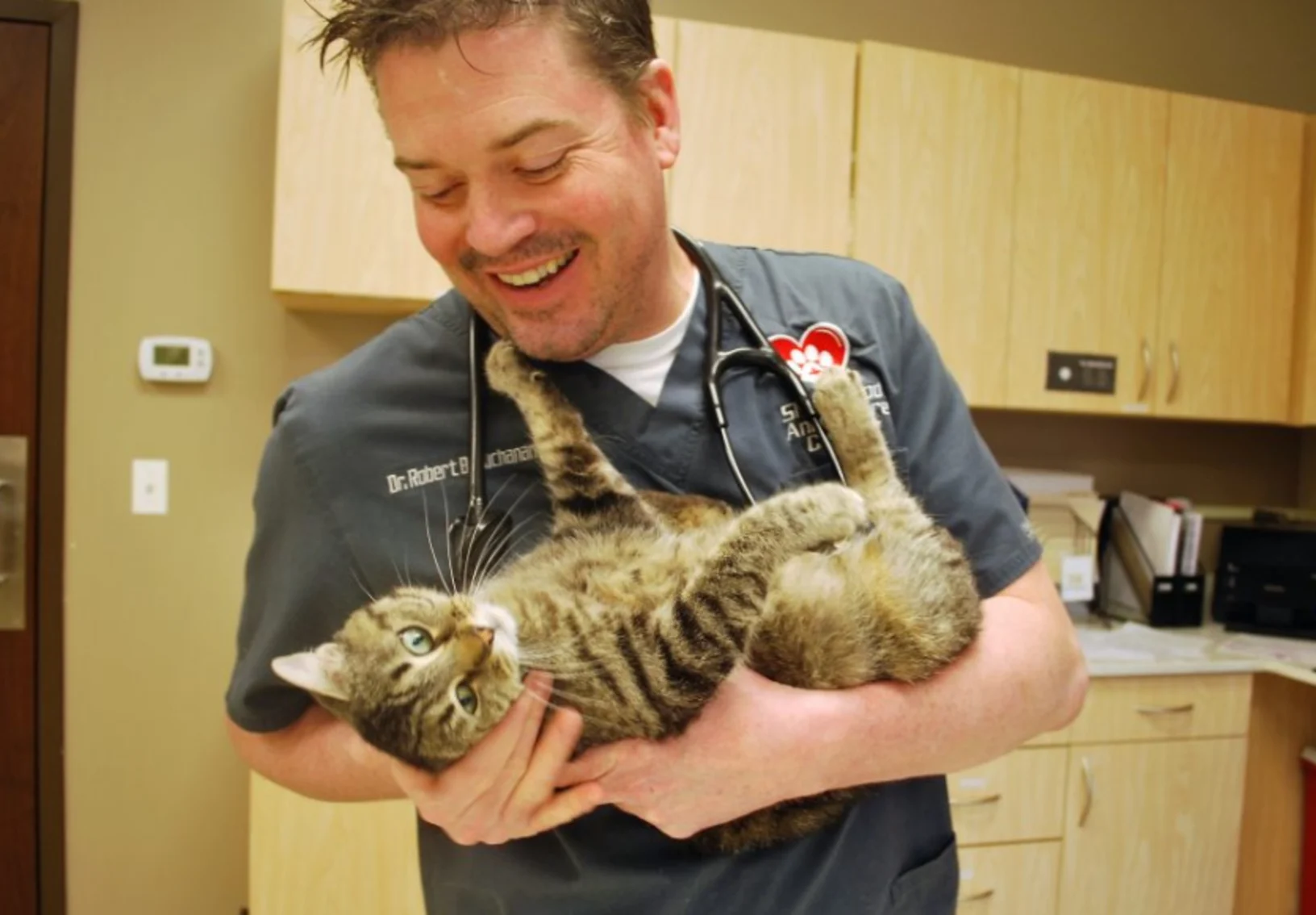 Animal Care Center of Shorewood Doctor smiling and holding cat Animal Care Center of Shorewood Doctor smiling and holding cat
