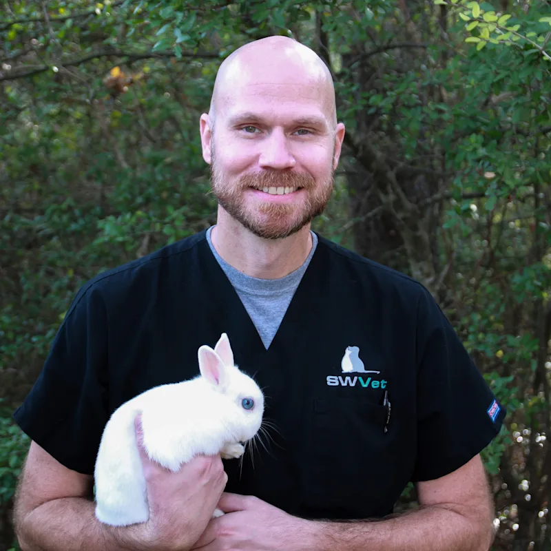 Dr. Brad Singleton Holding a White Bunny Dr. Brad Singleton Holding a White Bunny