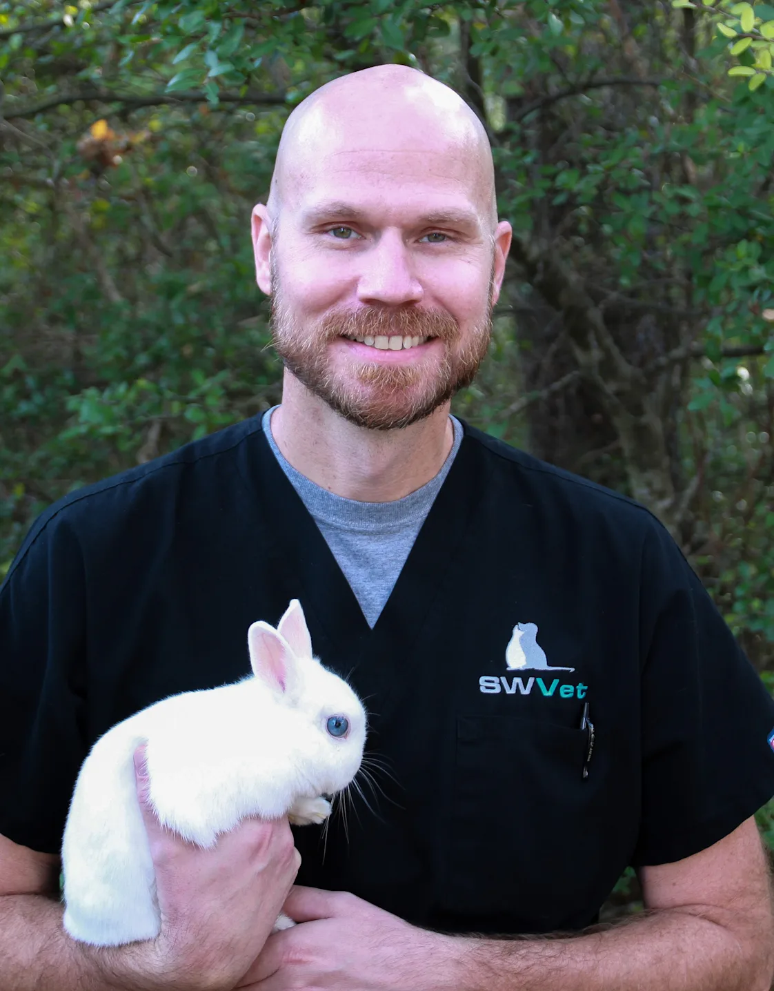 Dr. Brad Singleton Holding a White Bunny Dr. Brad Singleton Holding a White Bunny