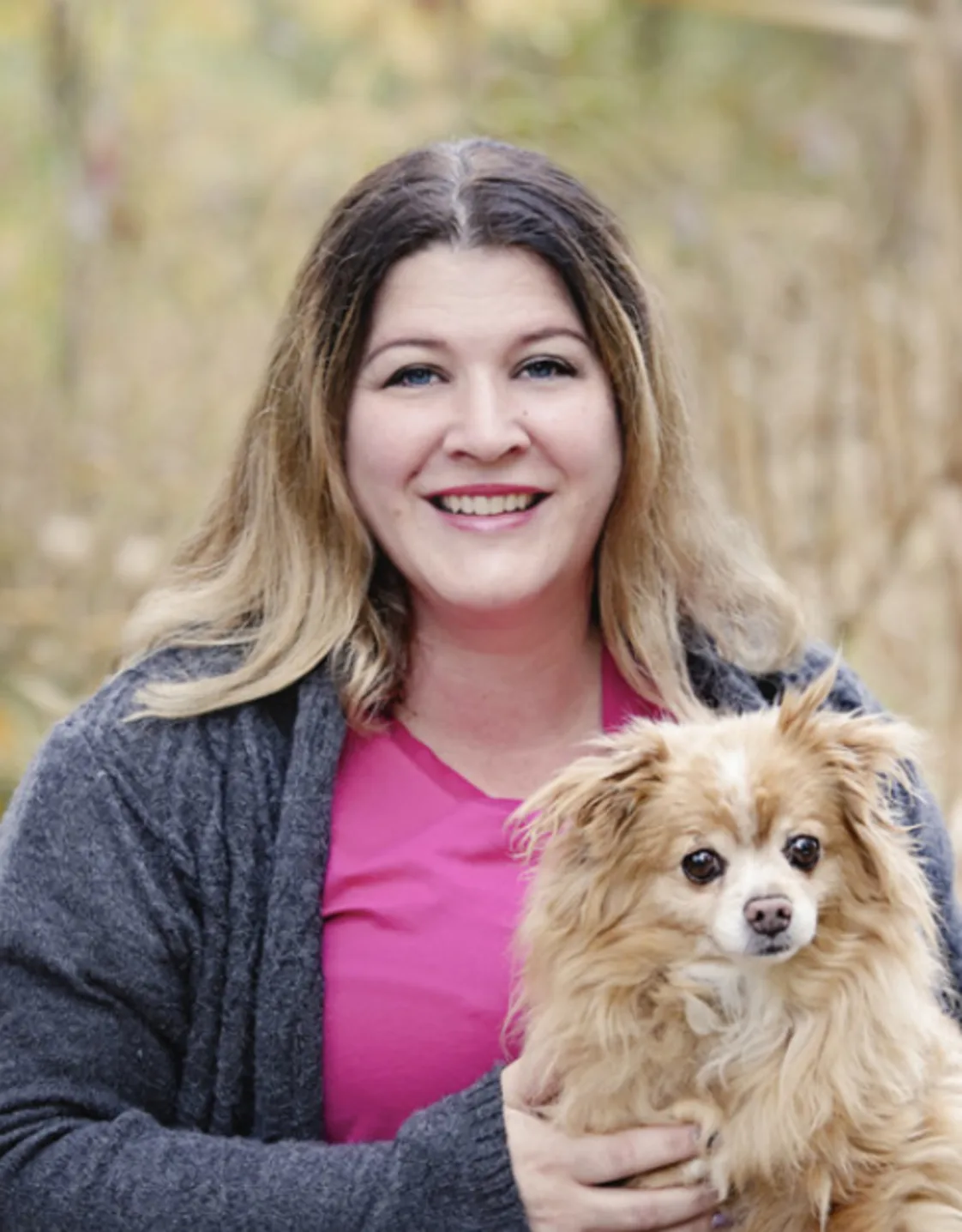Anne holding a golden fluffy dog Anne holding a golden fluffy dog