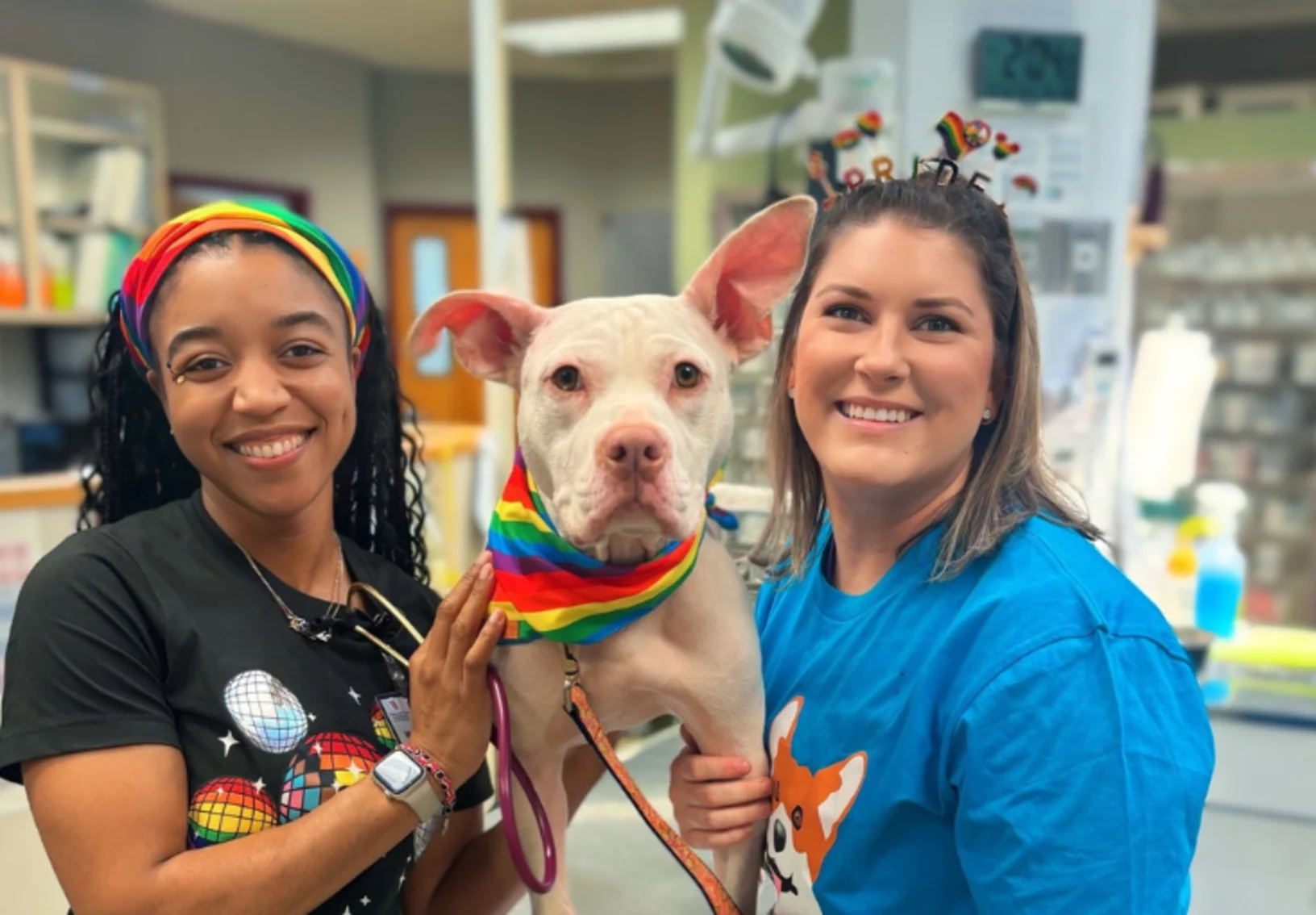 Staff members Martia and Brandie with a dog Staff members Martia and Brandie with a dog