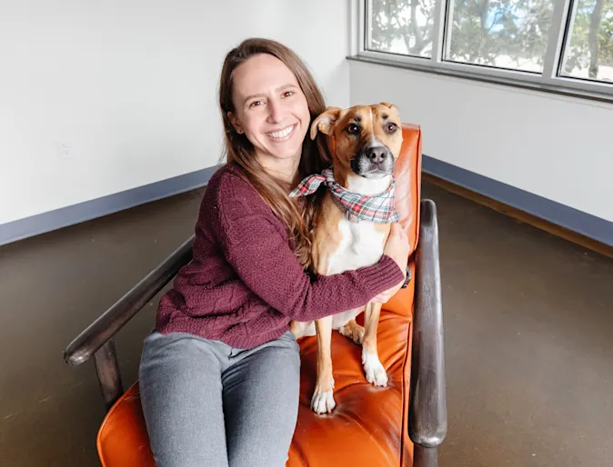 Smiling woman hugging a dog Smiling woman hugging a dog