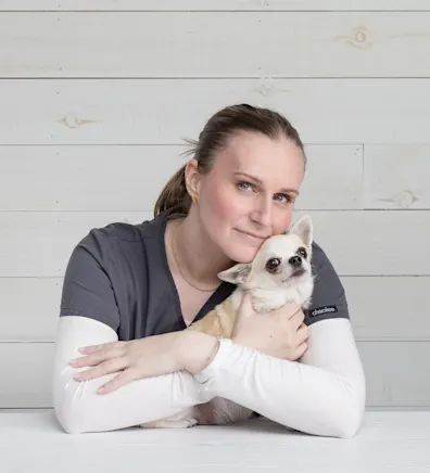 Maja holding a stuffed animal dog with a cone Maja holding a stuffed animal dog with a cone
