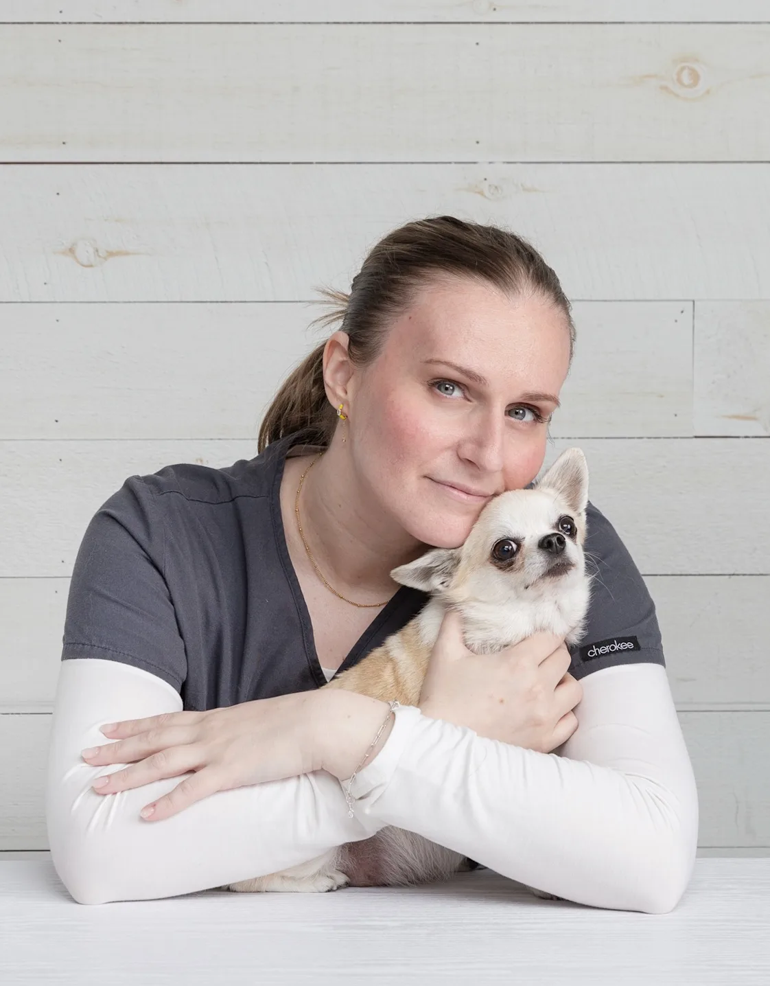 Maja holding a stuffed animal dog with a cone Maja holding a stuffed animal dog with a cone