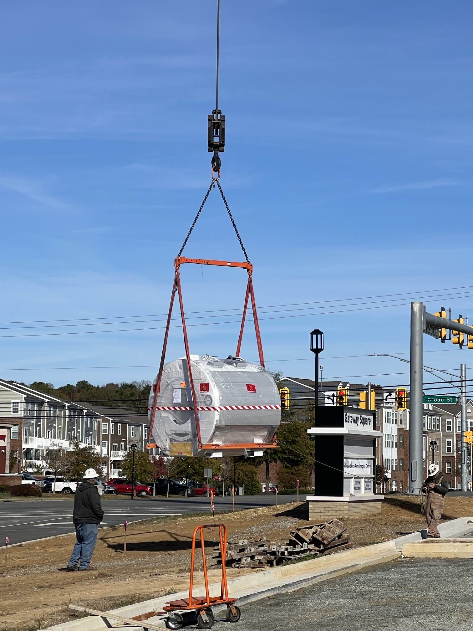 Construction crew using crane to move in MRI machine