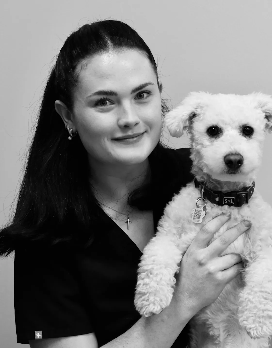 Taylor holding onto a curly haired dog. Taylor holding onto a curly haired dog.