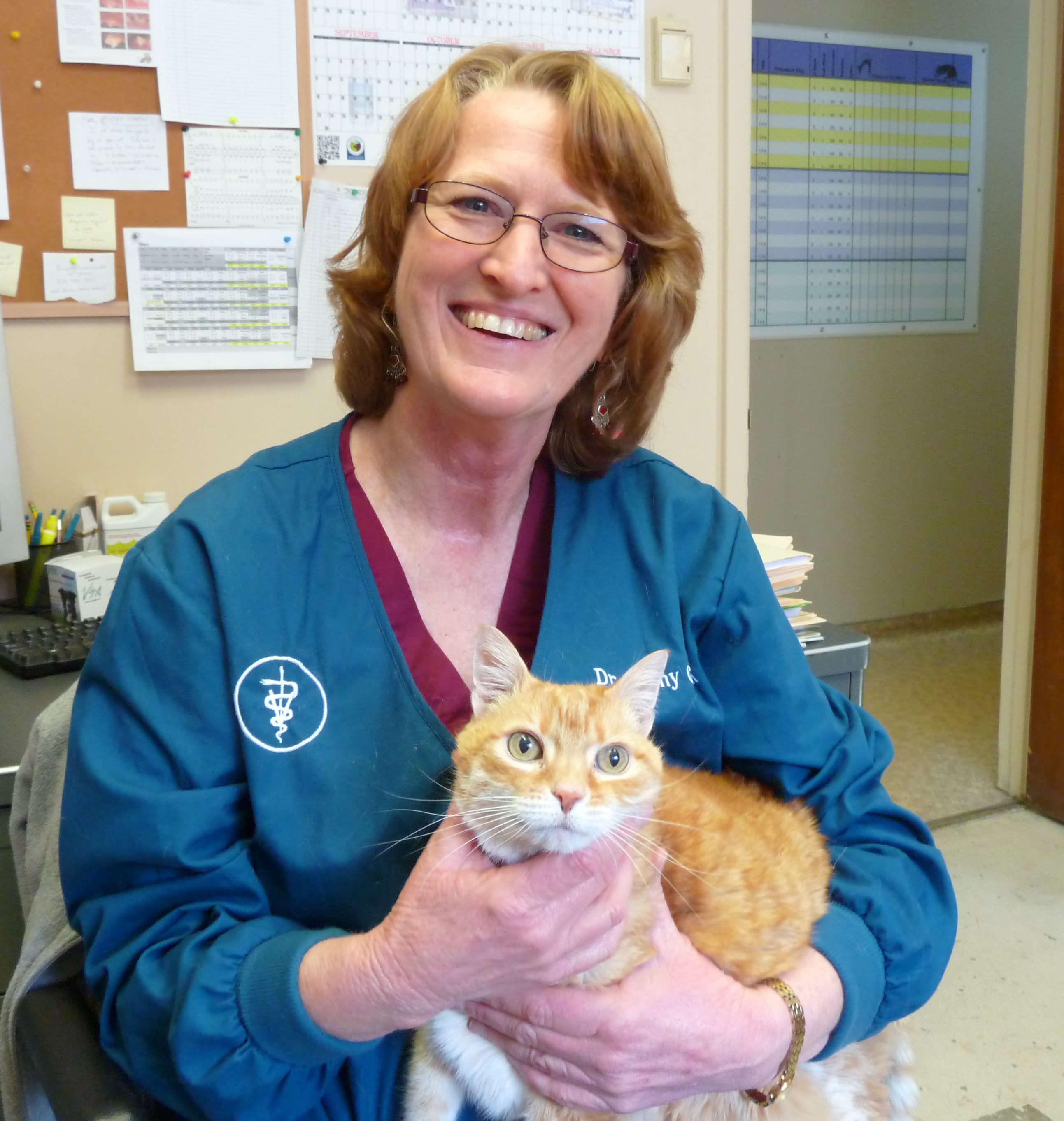 Cathy Glahn  holding an orange tabby cat