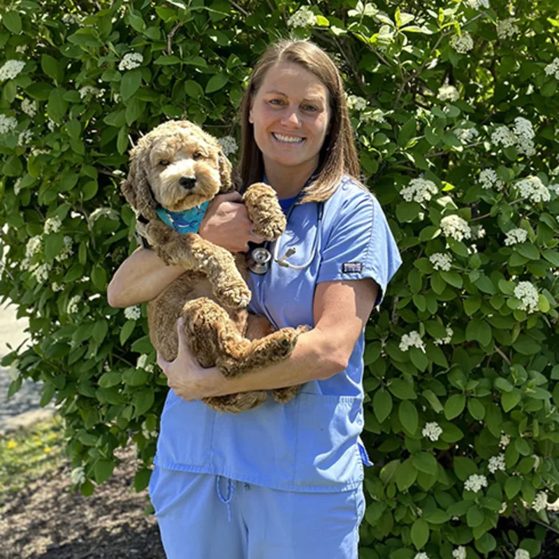 Dr. Jami Fourez holding a small dog outside Dr. Jami Fourez holding a small dog outside