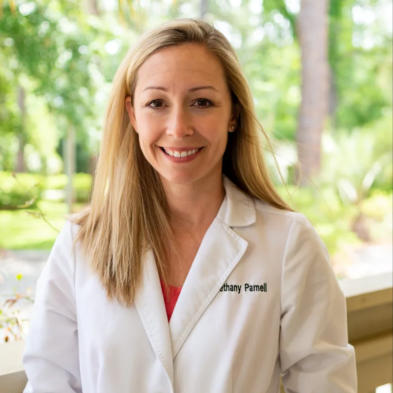 Dr. Bethany Parnell's staff photo from Plantation Animal Hospital smiling outside with the trees in the background Dr. Bethany Parnell's staff photo from Plantation Animal Hospital smiling outside with the trees in the background