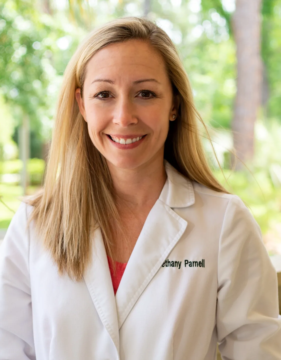 Dr. Bethany Parnell's staff photo from Plantation Animal Hospital smiling outside with the trees in the background Dr. Bethany Parnell's staff photo from Plantation Animal Hospital smiling outside with the trees in the background