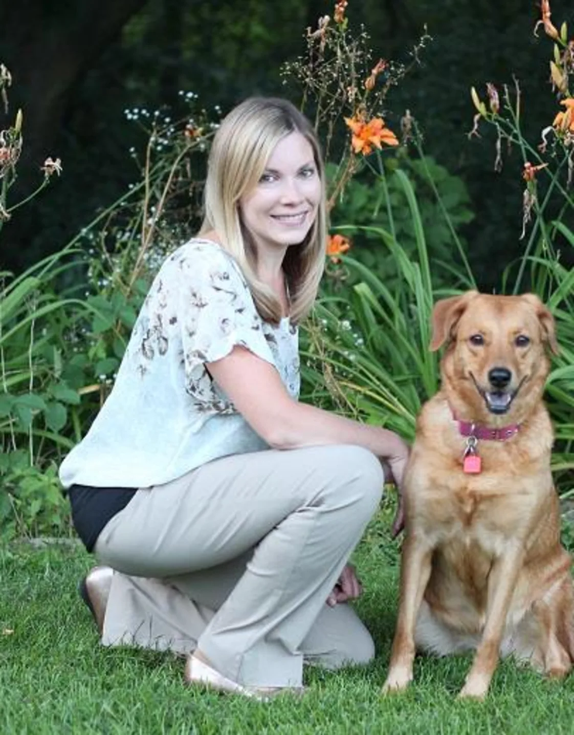 Dr. Kristine Kistner's staff photo from North Lake Veterinary Clinic and her golden retriever next to her posing outside on a lawn  Dr. Kristine Kistner's staff photo from North Lake Veterinary Clinic and her golden retriever next to her posing outside on a lawn