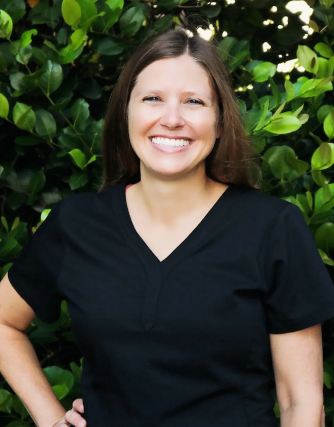 Dr. Kelly smiling with a two cute dogs beside her Dr. Kelly smiling with a two cute dogs beside her