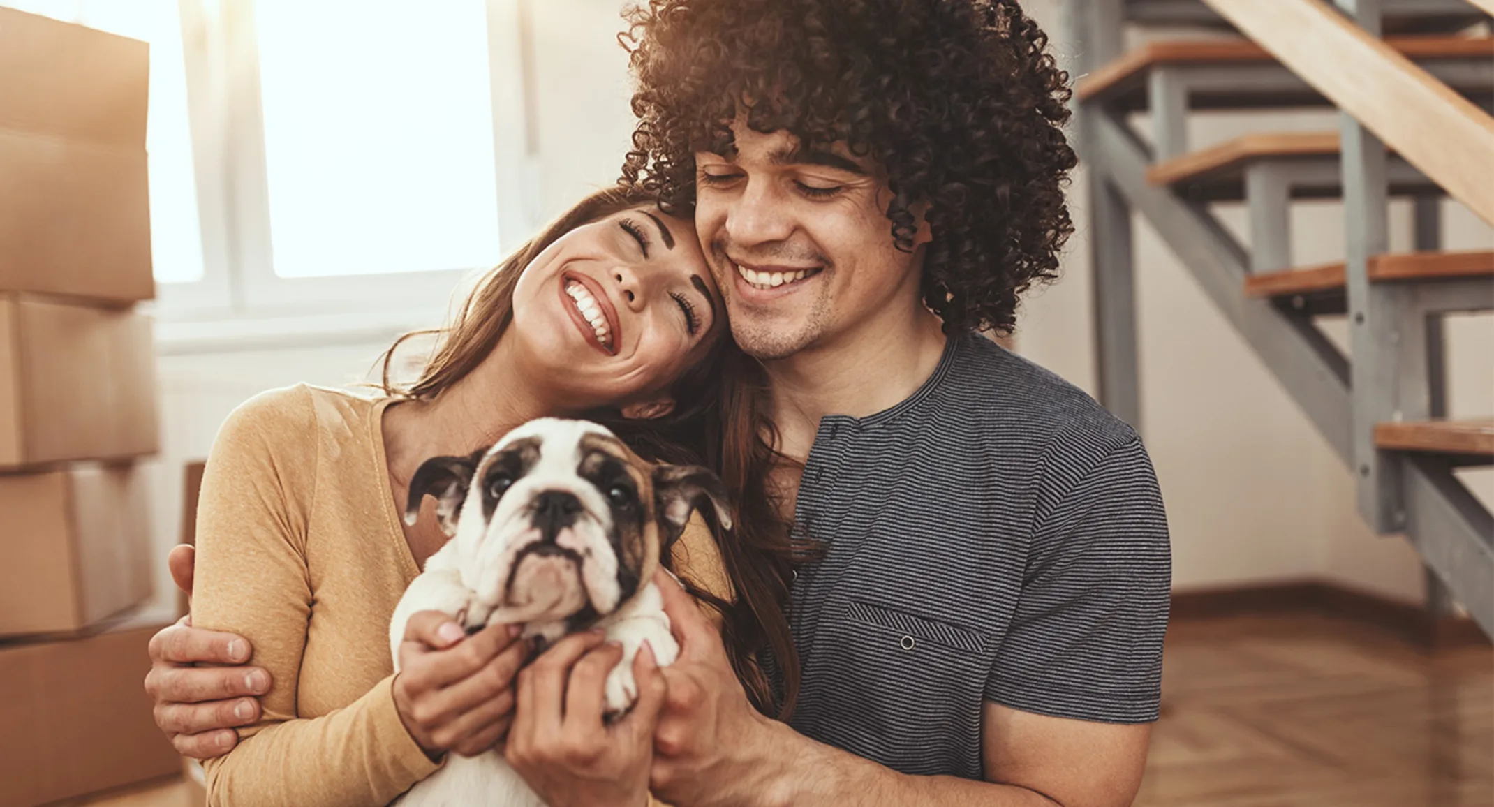 Family with puppy indoors with moving boxes. Family with puppy indoors with moving boxes.