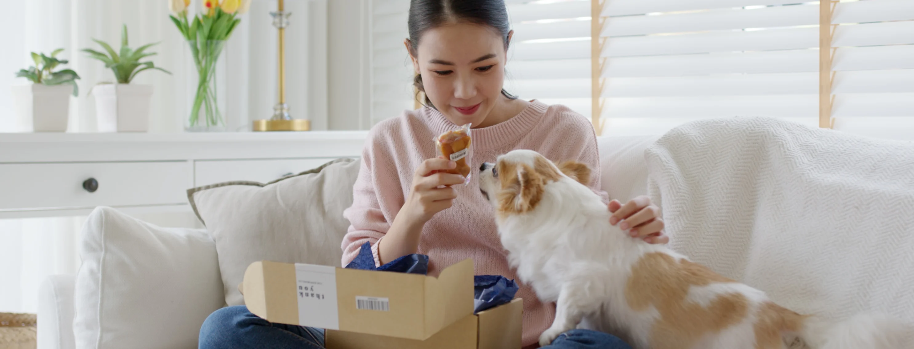 Girl Giving Dog a Treat From Package Girl Giving Dog a Treat From Package
