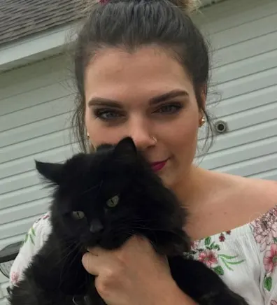 Maegan Middleton holding a black cat Maegan Middleton holding a black cat
