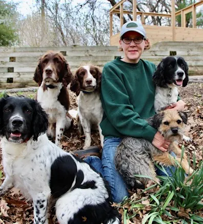 Nancy's staff photo from Stillwater Veterinary Clinic's and two dogs are besides her posing for a picture Nancy's staff photo from Stillwater Veterinary Clinic's and two dogs are besides her posing for a picture