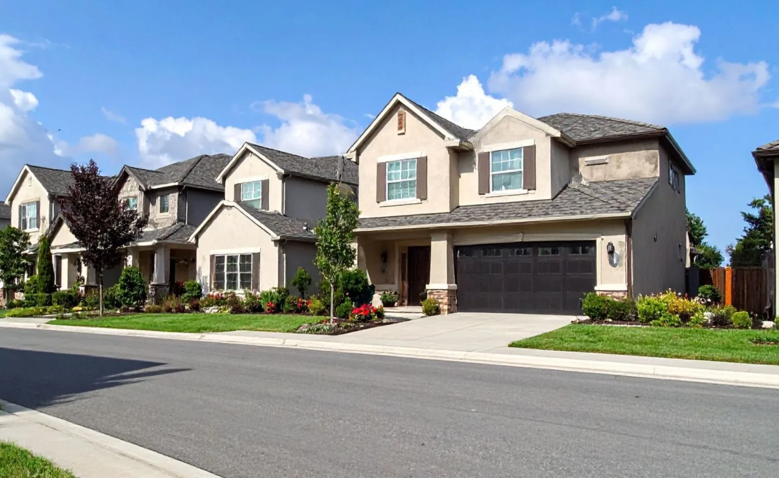 Beige suburban house sitting in a neighborhood. Beige suburban house sitting in a neighborhood.