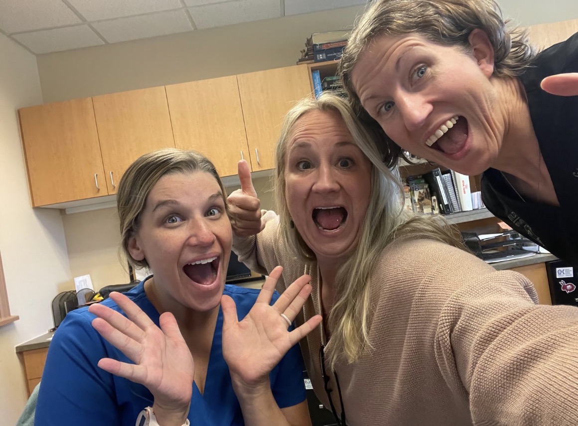 Three team members smiling