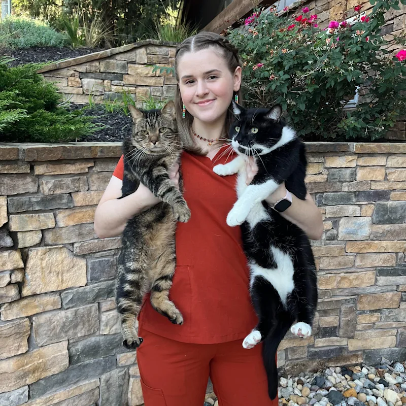 An assistant posing with a dog An assistant posing with a dog