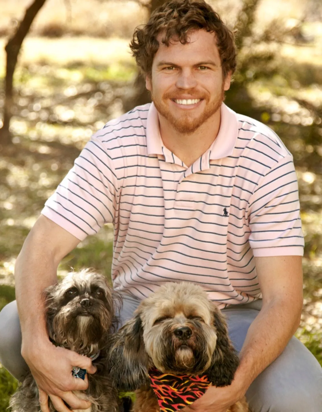 Dr. Shuman in field with two small dogs Dr. Shuman in field with two small dogs