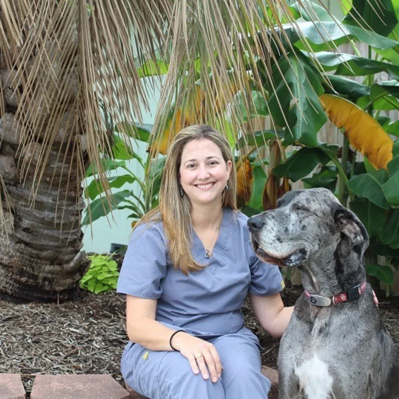 A portrait of Dr. Anna McBride smiling indoors against a beige background A portrait of Dr. Anna McBride smiling indoors against a beige background