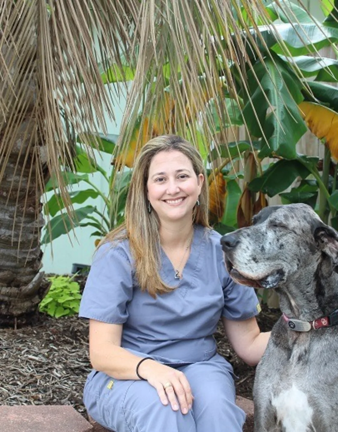 A portrait of Dr. Anna McBride smiling indoors against a beige background A portrait of Dr. Anna McBride smiling indoors against a beige background