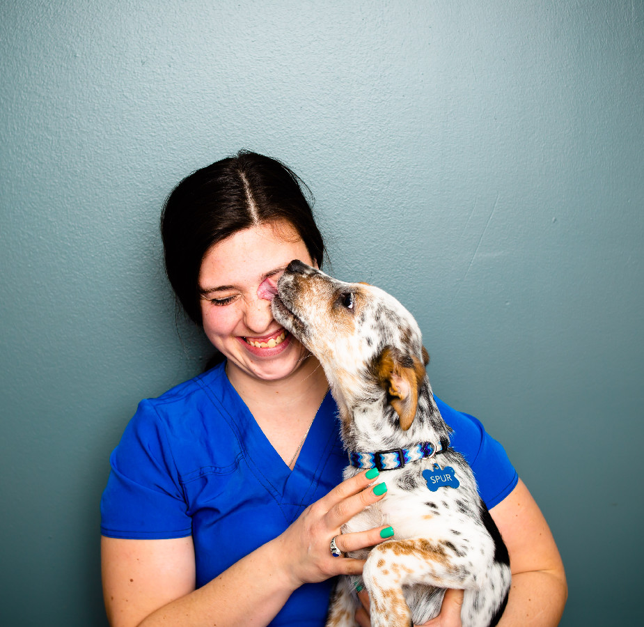 A Kindness Animal Hospital staff member with a dog