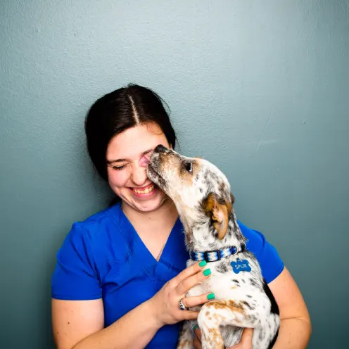 A Kindness Animal Hospital staff member with a dog