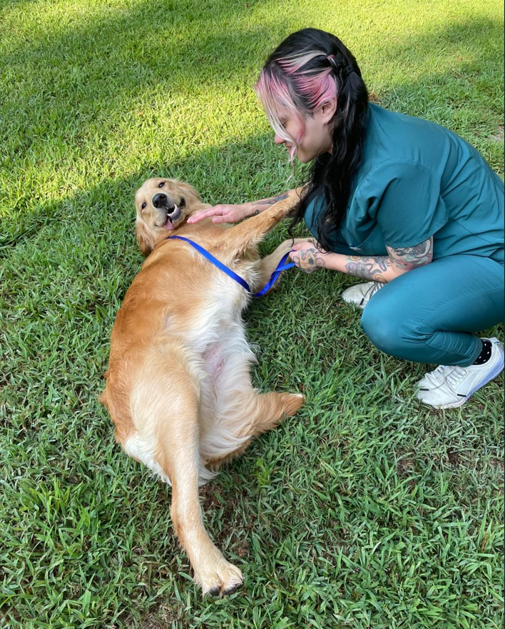 Alex and Tinkerbell playing in the grass