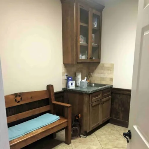 An exam room at Shady Brook Animal Hospital featuring a bench for pet parents and a work area for staff