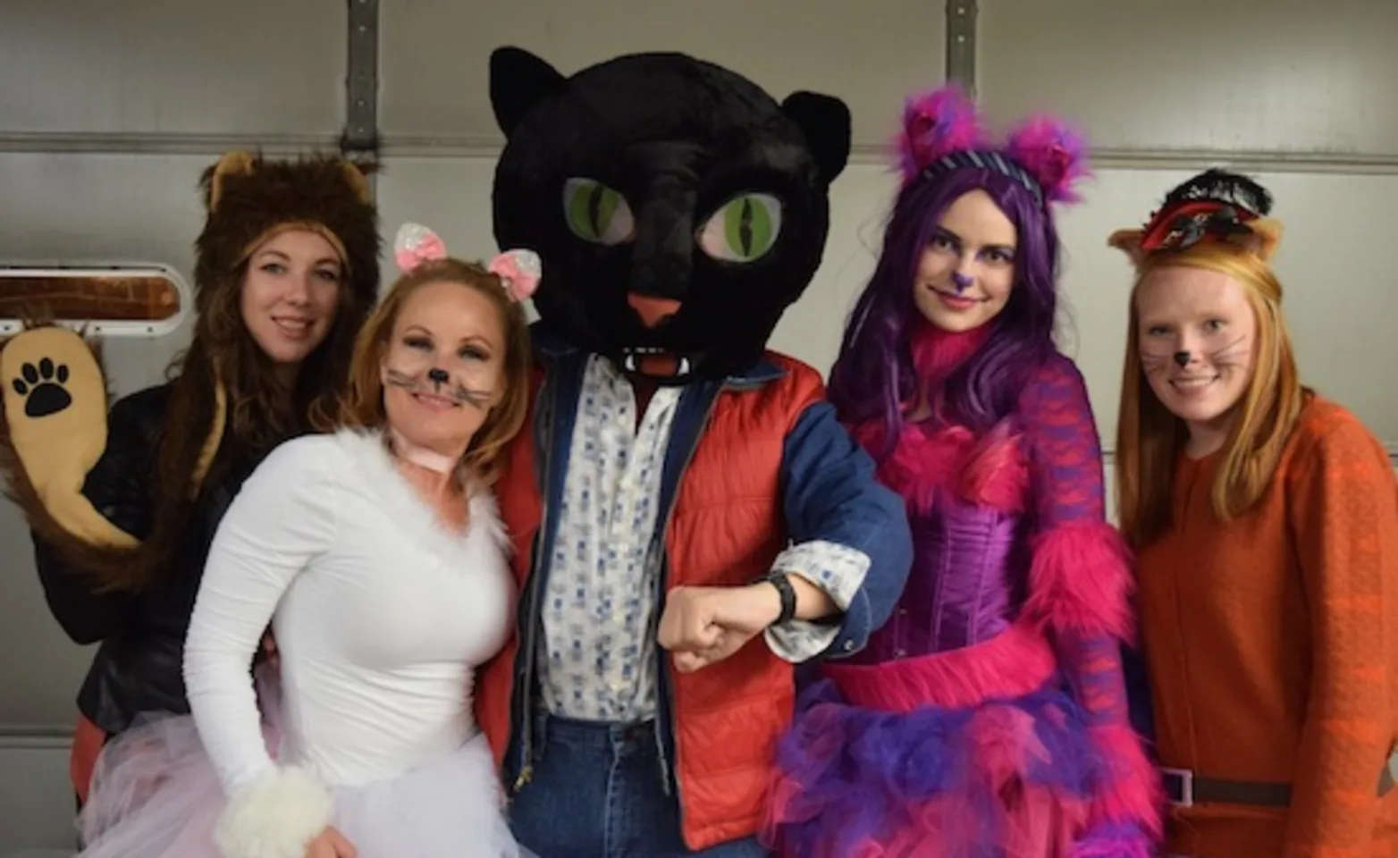 People wearing cat themed costumes People wearing cat themed costumes