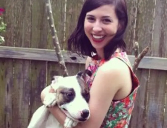 A woman holds a dog A woman holds a dog