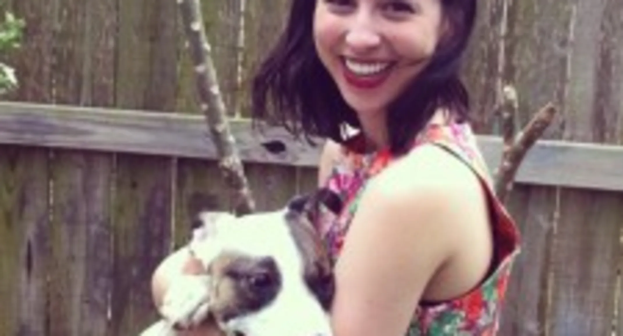 A woman holds a dog A woman holds a dog