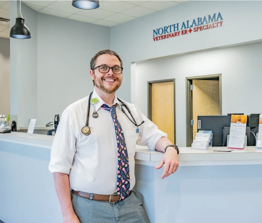 Dr. Wood leaning against NAVES' reception desk.