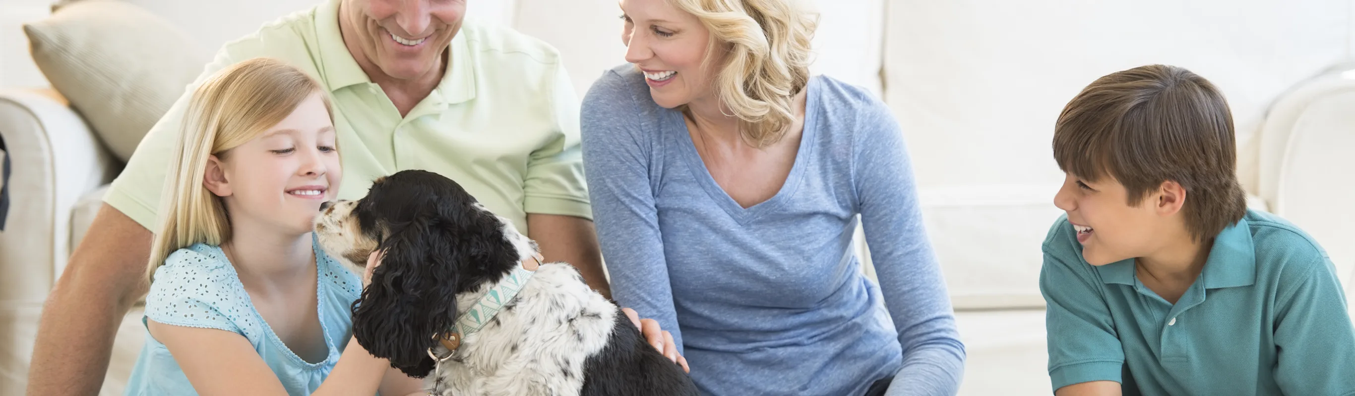 family and dog sitting in living room family and dog sitting in living room