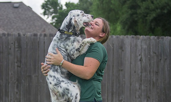 Trainer holding spotted dog