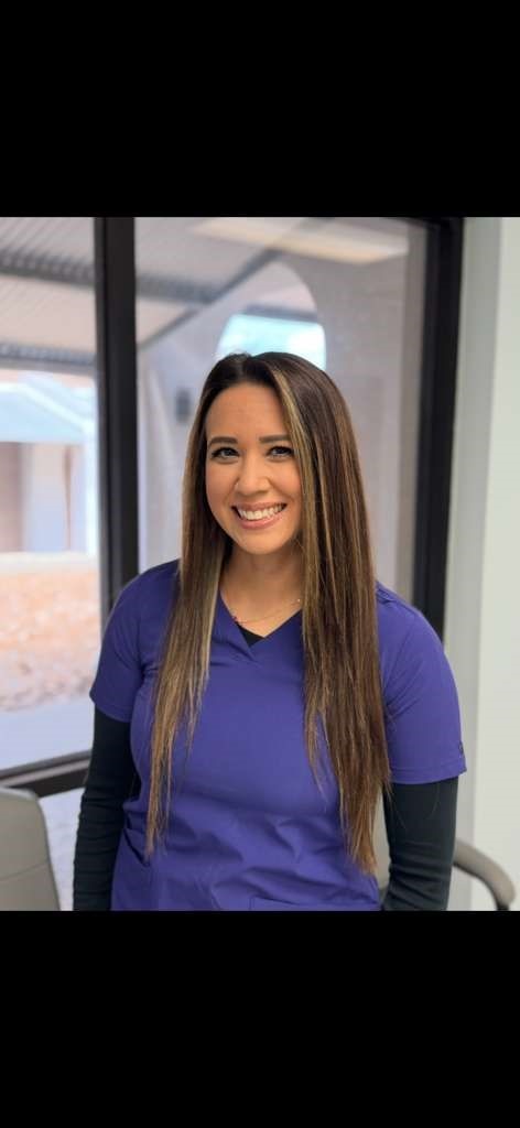 Katie Martinez sitting down with a brown dog