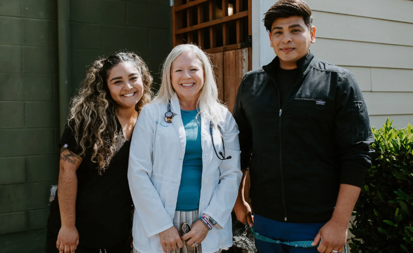 Jennifer, Dr. Jody, and Rayson all standing together smiling