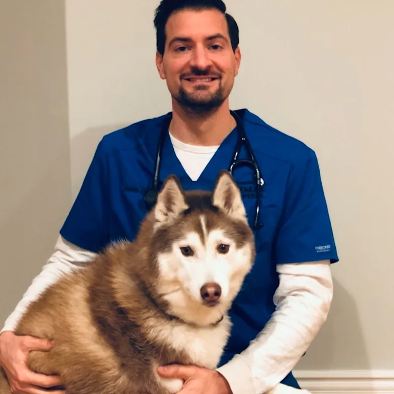 Justin Cutillo sitting with a dog Justin Cutillo sitting with a dog