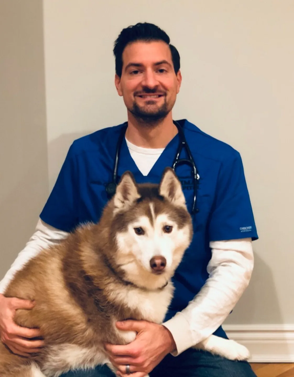 Justin Cutillo sitting with a dog Justin Cutillo sitting with a dog