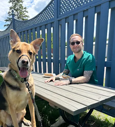 Trent in a car with his dog laying their head on his shoulder Trent in a car with his dog laying their head on his shoulder