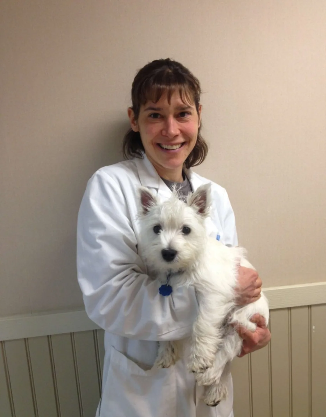DVM Laurie Farragher holding a dog DVM Laurie Farragher holding a dog