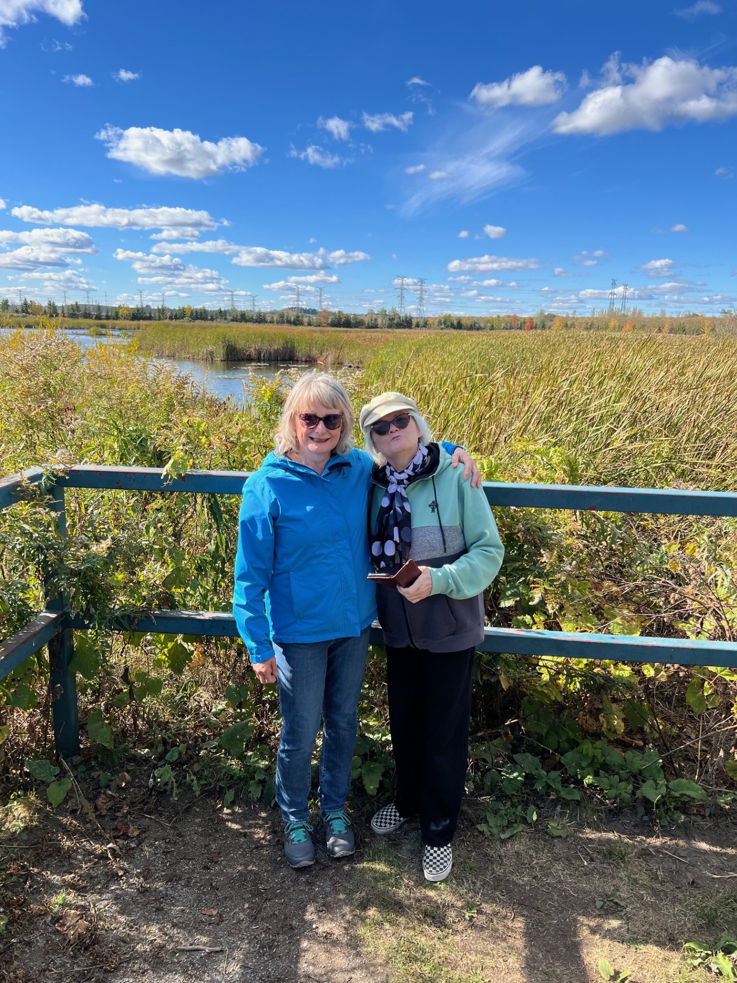 Sandra McBride smiling in nature with a friend.