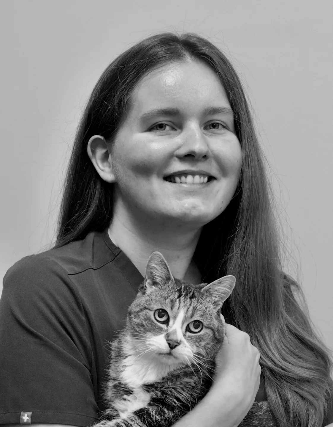 Nataliia holding onto a cat and smiling for a photo Nataliia holding onto a cat and smiling for a photo