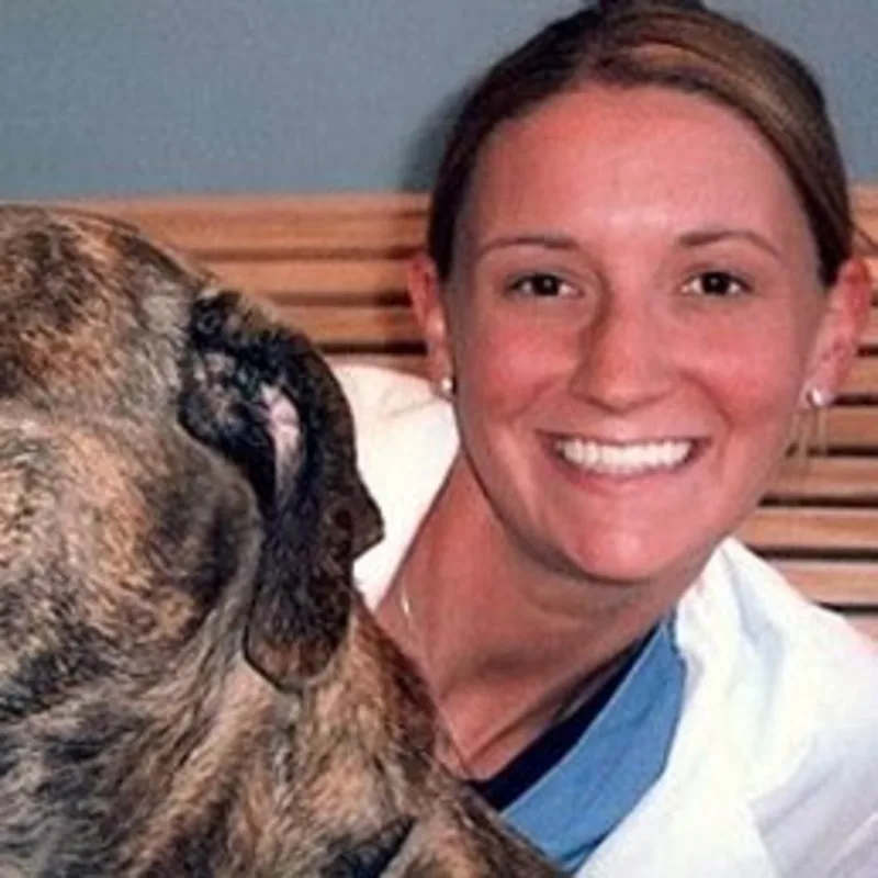 Dr. Miller with a dog. Dr. Miller with a dog.