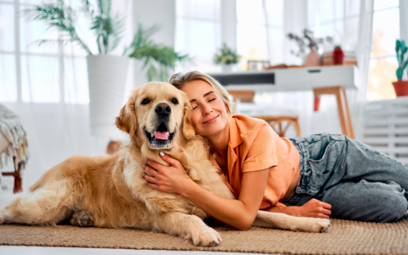 Girl Laying on the Floor Hugging Her Senior/Older Dog